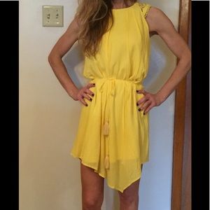Yellow flowy dress with tie at waist.